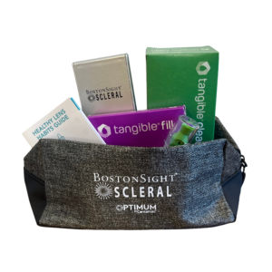 Image of a zippered pouch that says "BostonSight SCLERAL" on the outside, filled with, a "Healthy Lens Habits Guide" pamphlet, box of "Tangible Fill", box of "Tangible Clean", a ScleralEase applicator/remover tool, and a mini foldable mirror.